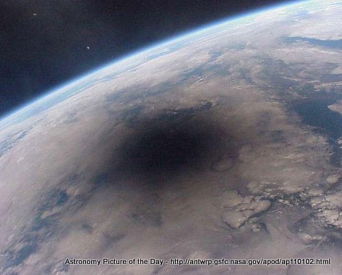 Looking Back at an Eclipsed Earth, photograph from MIR space station on 11 Aug '99